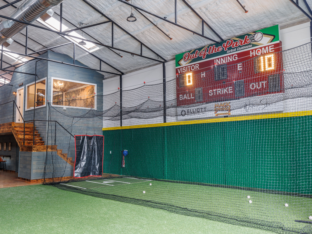 Indoor batting cage and baseball scoreboard